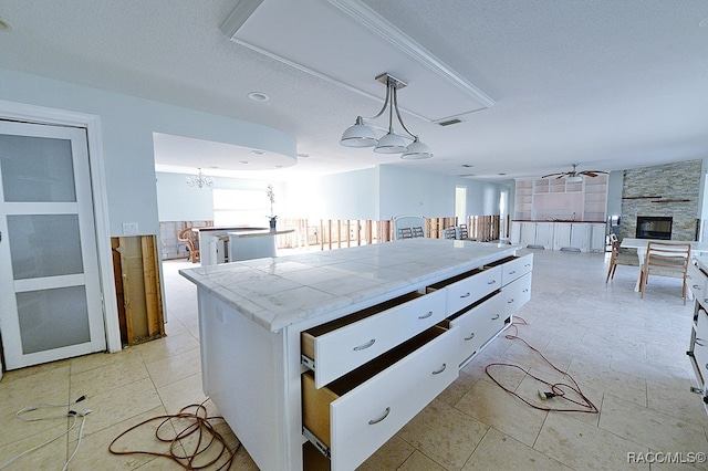 kitchen with white cabinets, plenty of natural light, and pendant lighting