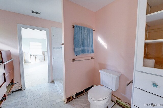 bathroom featuring toilet and walk in shower