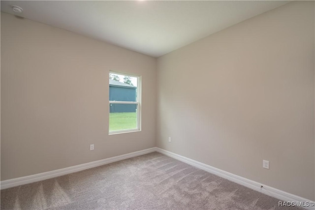 9262 N Alpinia Dr, Citrus Springs, FL 34434 - empty room featuring carpet, baseboards, and a smoke detector