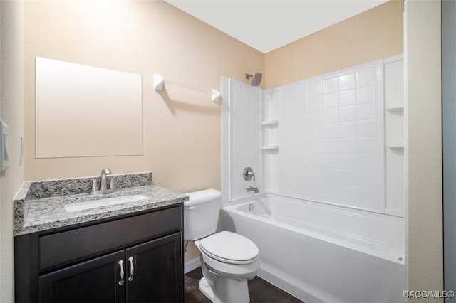 bathroom with baseboards, toilet, shower / tub combination, wood finished floors, and vanity