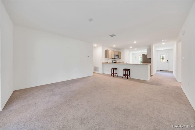 1435 W Adele Ct, Citrus Springs, FL 34434 - unfurnished living room featuring light colored carpet and recessed lighting