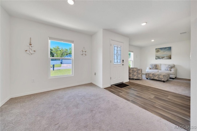 1435 W Adele Ct, Citrus Springs, FL 34434 - carpeted entrance foyer featuring baseboards, recessed lighting, and wood finished floors