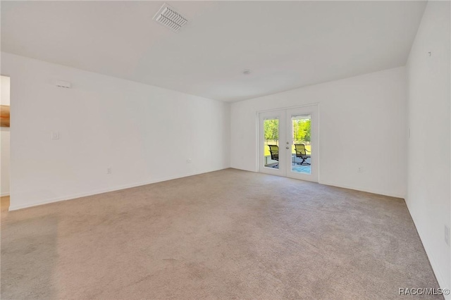 1435 W Adele Ct, Citrus Springs, FL 34434 - carpeted empty room with french doors