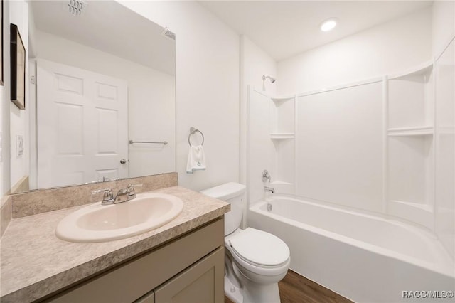 1435 W Adele Ct, Citrus Springs, FL 34434 - bathroom with toilet, vanity, tub / shower combination, and wood finished floors