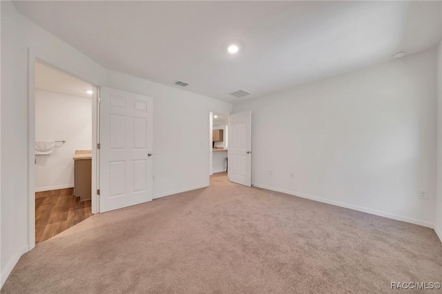 1435 W Adele Ct, Citrus Springs, FL 34434 - unfurnished bedroom with carpet flooring, a walk in closet, baseboards, and recessed lighting