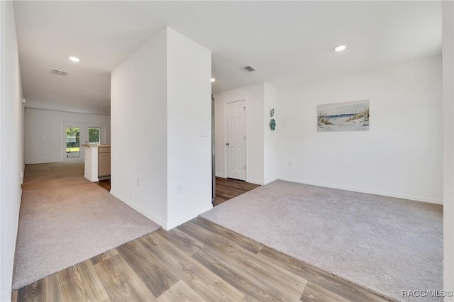 1435 W Adele Ct, Citrus Springs, FL 34434 - carpeted empty room with wood finished floors, recessed lighting, and baseboards