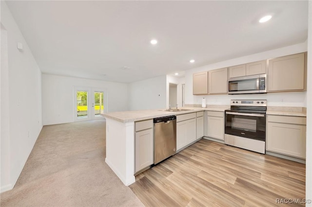 1435 W Adele Ct, Citrus Springs, FL 34434 - kitchen with stainless steel appliances, a peninsula, light countertops, a sink, and recessed lighting