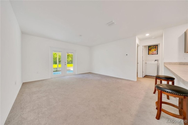 1435 W Adele Ct, Citrus Springs, FL 34434 - unfurnished living room with french doors, washer / dryer, light carpet, and recessed lighting