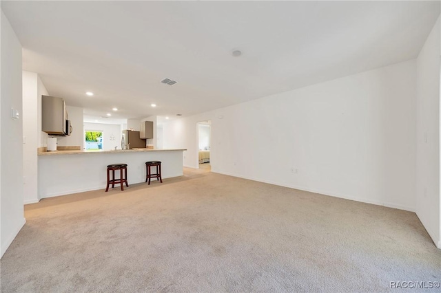1435 W Adele Ct, Citrus Springs, FL 34434 - unfurnished living room with light colored carpet and recessed lighting