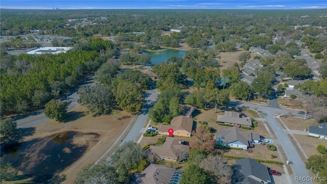 aerial view with a forest view, a residential view, and a water view