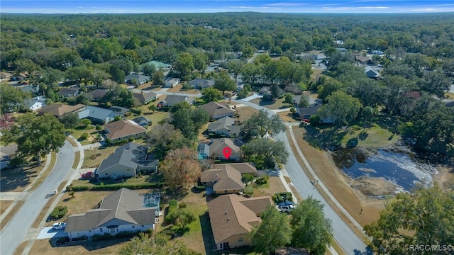 bird's eye view with a wooded view and a residential view