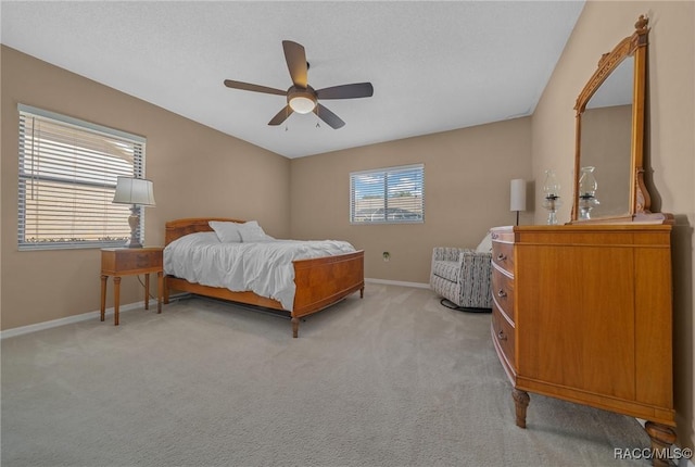 bedroom with baseboards, light carpet, and ceiling fan