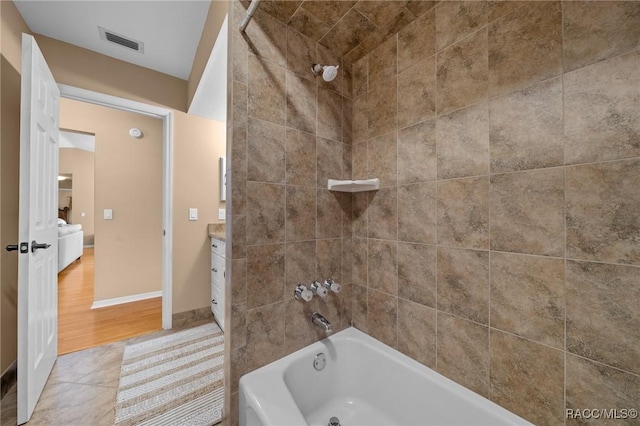 bathroom with vanity, baseboards, visible vents, shower / bath combination, and tile patterned floors