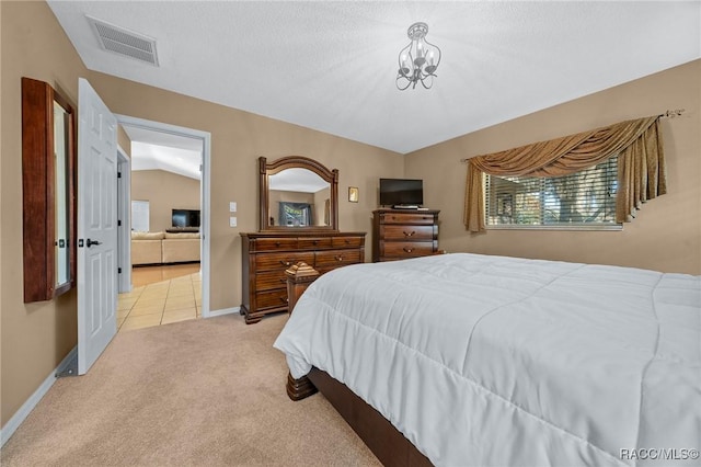 bedroom featuring a notable chandelier, visible vents, light colored carpet, and baseboards