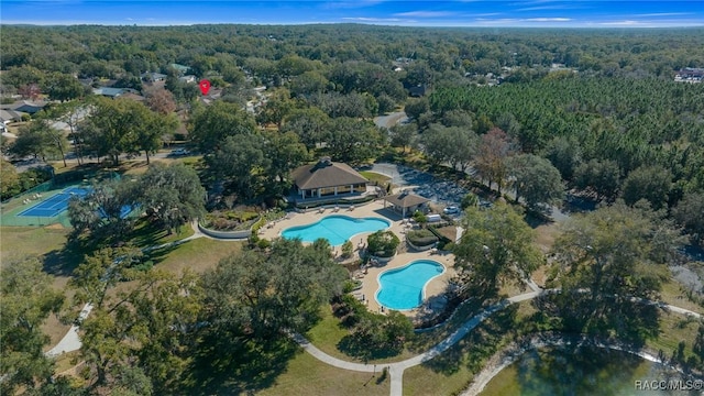 birds eye view of property featuring a wooded view