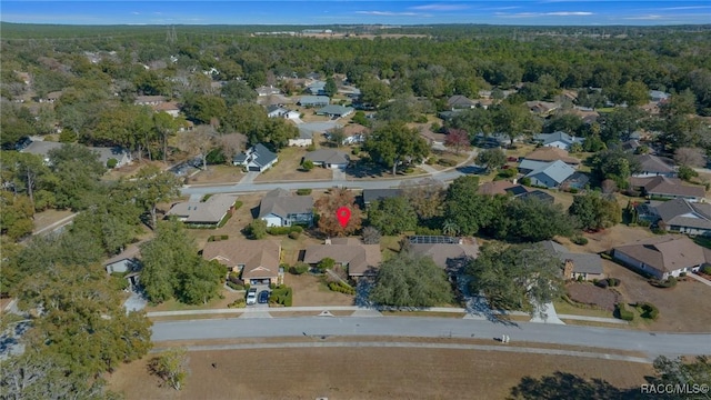 drone / aerial view featuring a view of trees and a residential view