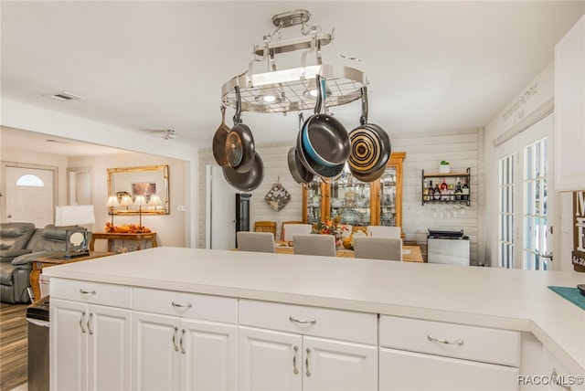 kitchen with hardwood / wood-style flooring and white cabinetry