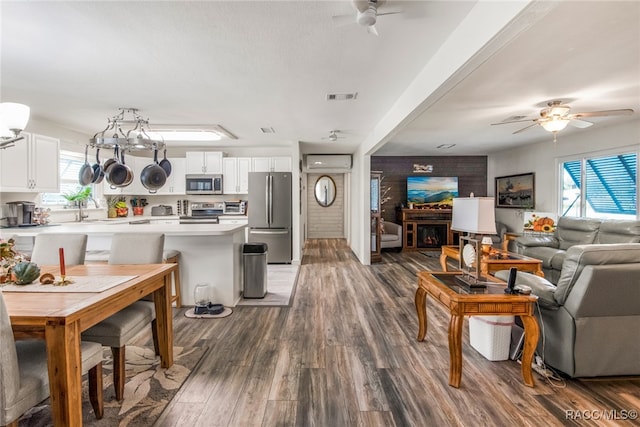 living room with ceiling fan, dark hardwood / wood-style flooring, and sink