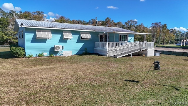 exterior space with ac unit and a front yard