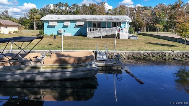 view of dock with a lawn and a deck with water view