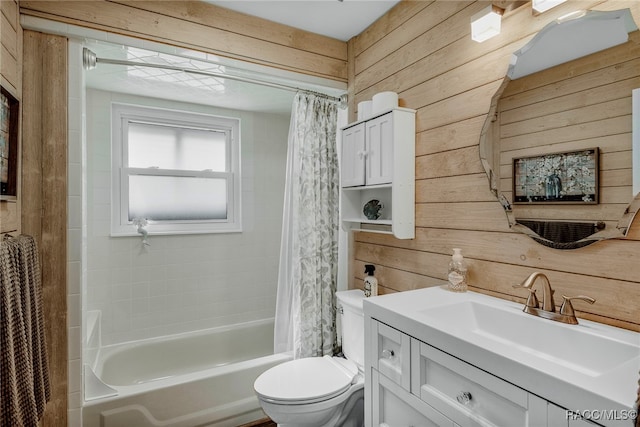 full bathroom featuring vanity, toilet, wooden walls, and shower / tub combo with curtain