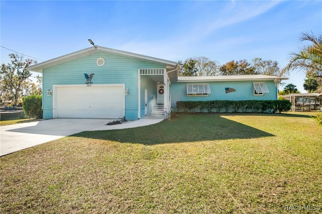 ranch-style house featuring a garage and a front lawn