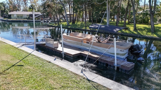 view of dock with a yard and a water view