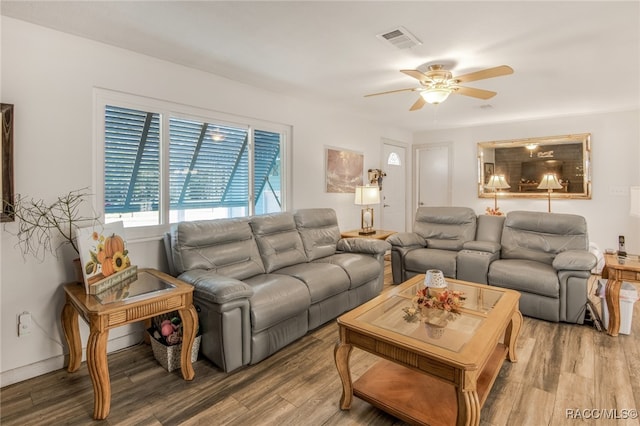 living room featuring hardwood / wood-style flooring and ceiling fan