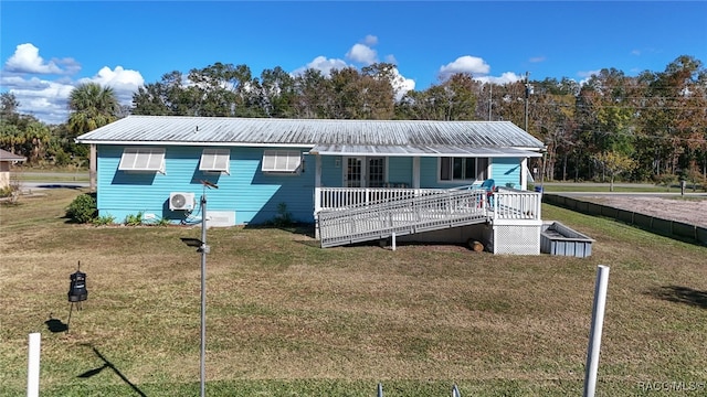 view of front of home with a wooden deck and a front lawn