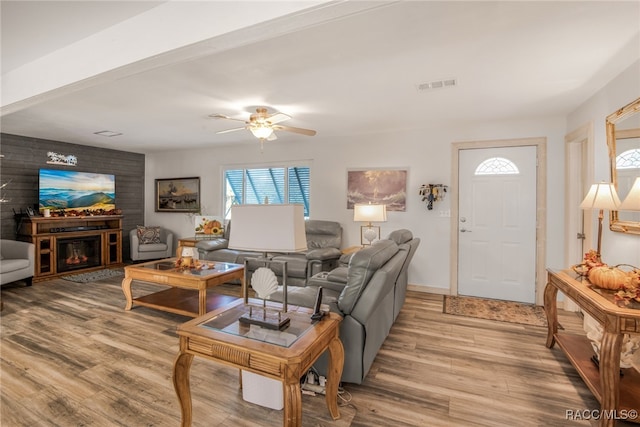 living room with light hardwood / wood-style floors and ceiling fan