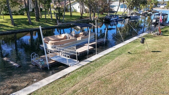 view of dock featuring a yard and a water view