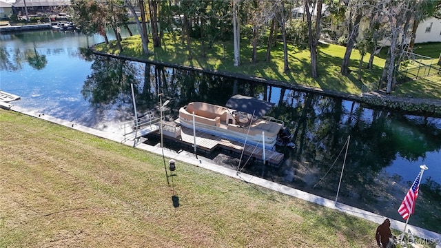 dock area with a water view and a yard