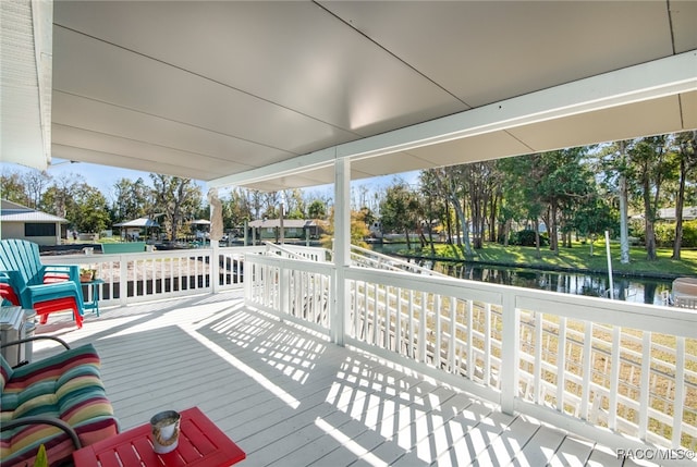 wooden terrace featuring a water view