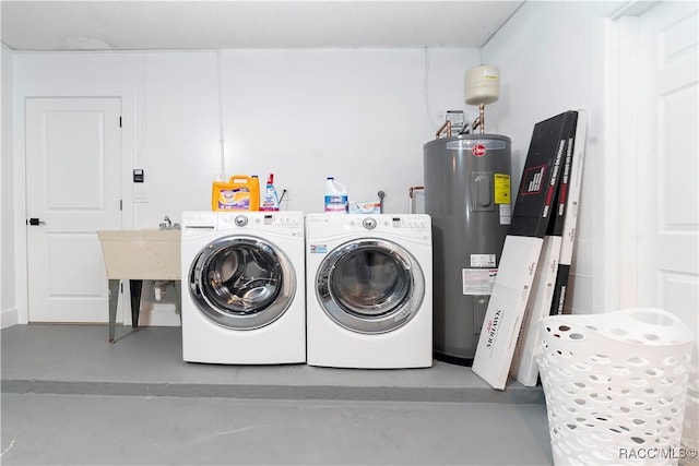 clothes washing area featuring laundry area, separate washer and dryer, and water heater