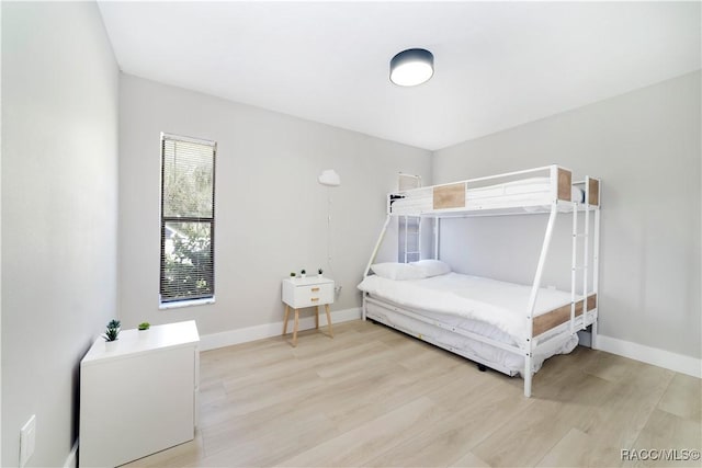 bedroom with baseboards and light wood-type flooring