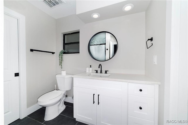 bathroom featuring vanity, tile patterned flooring, visible vents, toilet, and baseboards