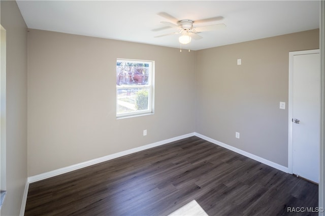 unfurnished room featuring ceiling fan and dark wood-type flooring