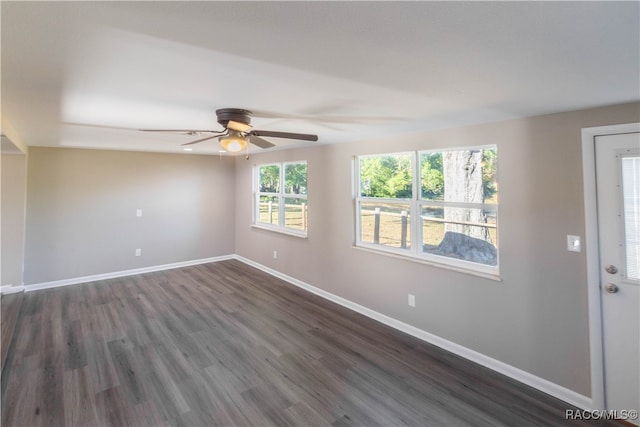 spare room featuring ceiling fan and dark hardwood / wood-style flooring