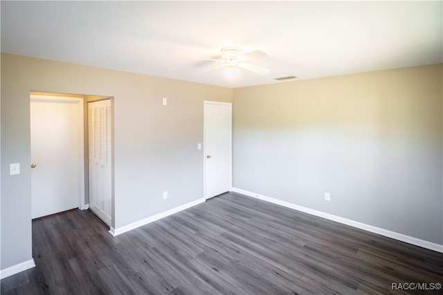 empty room featuring ceiling fan and dark hardwood / wood-style floors