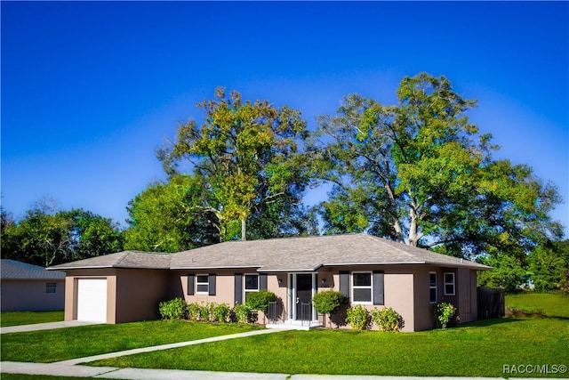 ranch-style house featuring a garage and a front lawn