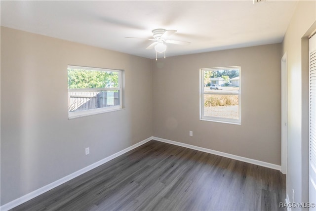 unfurnished room with ceiling fan and dark hardwood / wood-style flooring