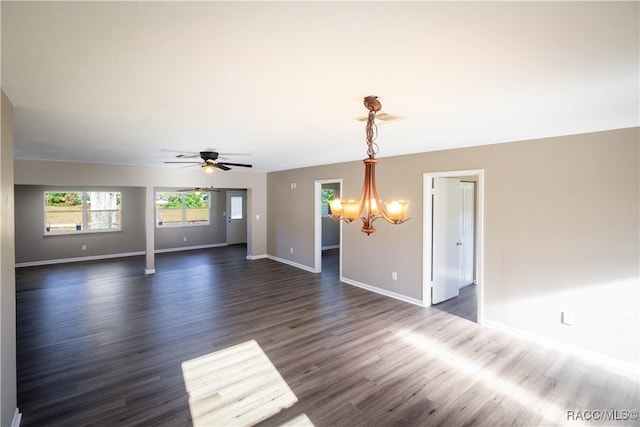 interior space featuring dark hardwood / wood-style flooring and ceiling fan with notable chandelier