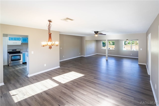 unfurnished living room with ceiling fan with notable chandelier and dark wood-type flooring