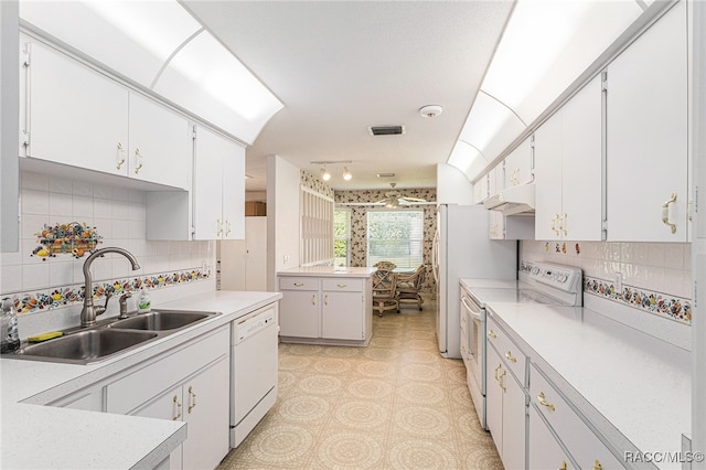 kitchen featuring white cabinetry, white appliances, sink, and tasteful backsplash