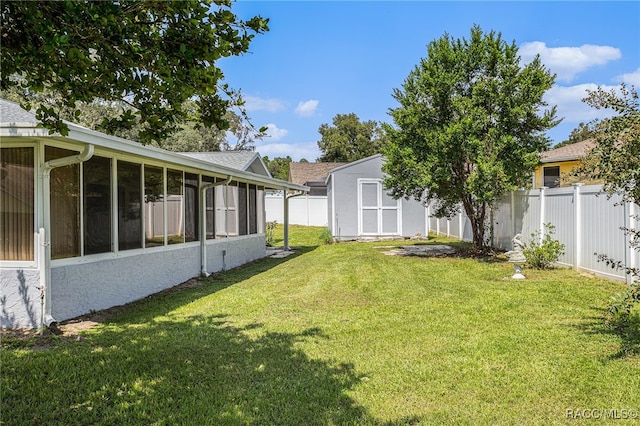 view of yard featuring a sunroom and a shed