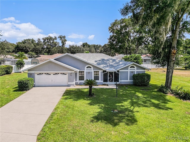 ranch-style home featuring a garage and a front lawn