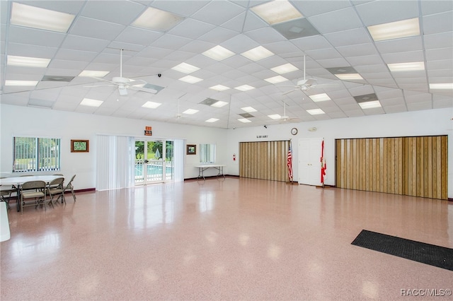 workout area with a paneled ceiling and ceiling fan