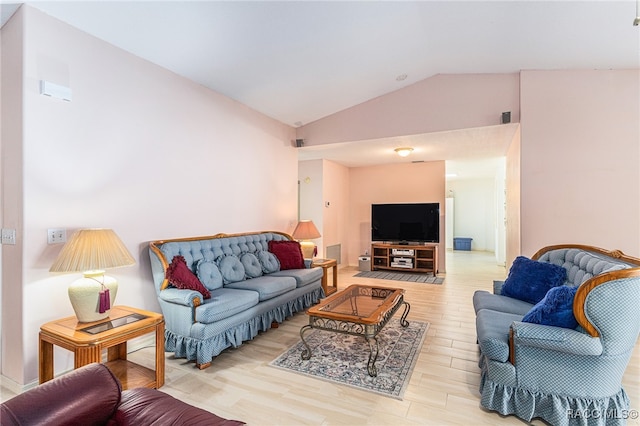 living room with light wood-type flooring and lofted ceiling