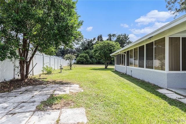 view of yard featuring a patio area and a sunroom