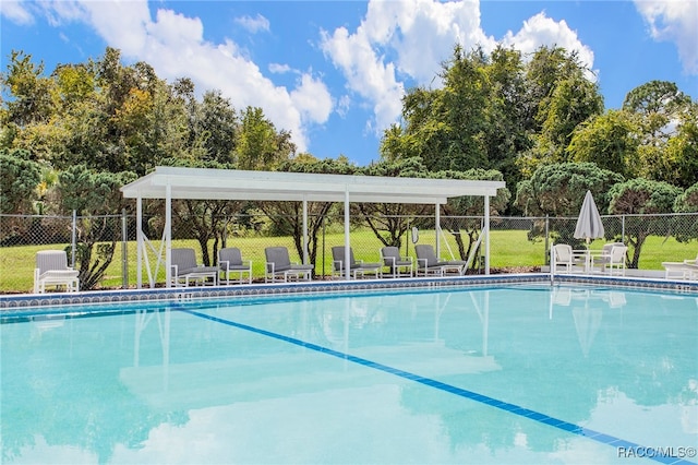 view of pool with a yard